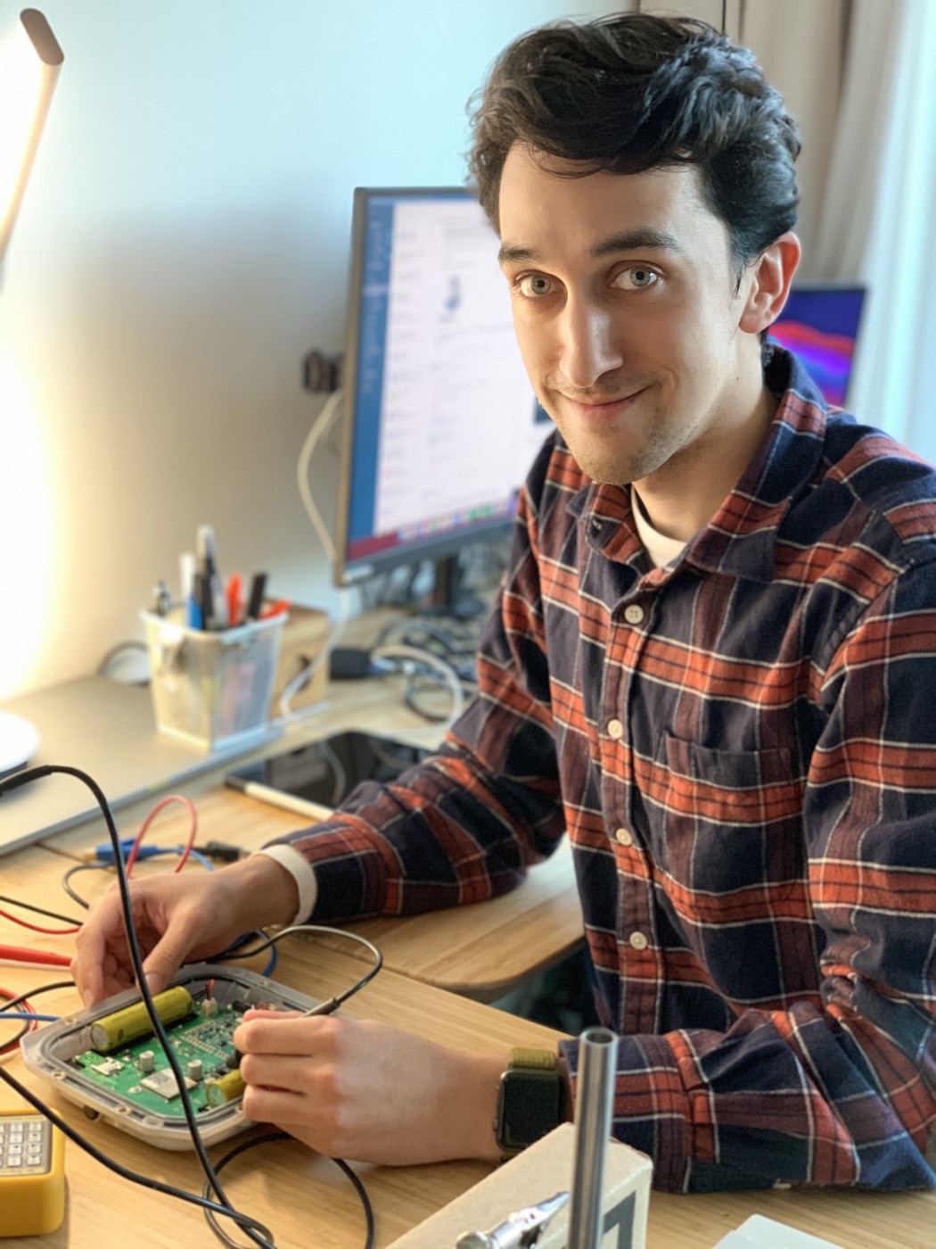 Michaël Devid probing the PadelPlay padel sensor circuit board on the bench