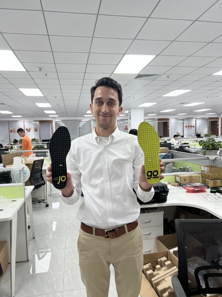 Holding the insole samples.