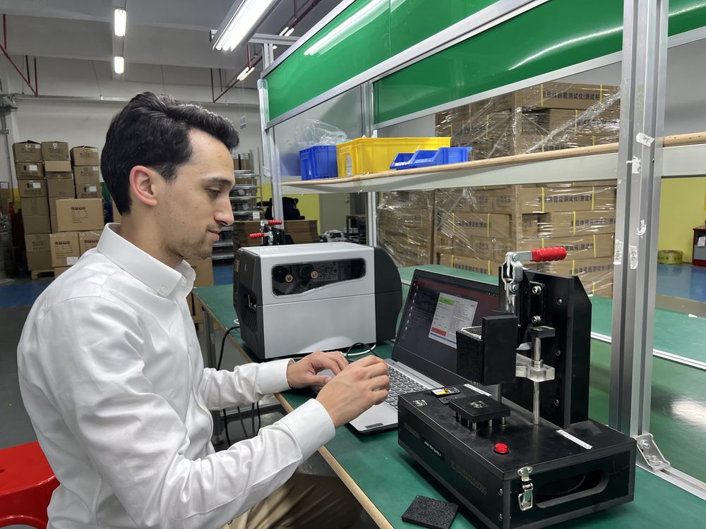 Factory PCBA testing and label-printing setup.